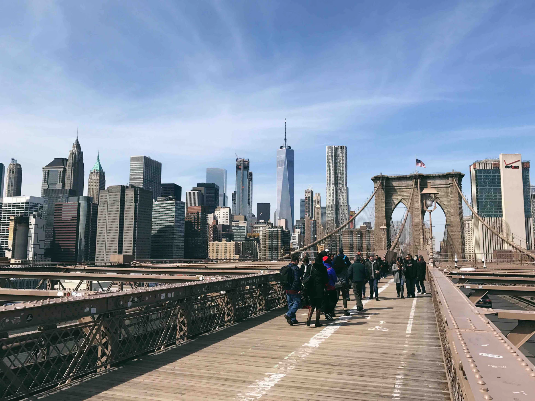 The original Brooklyn Bridge with some pedestrians.